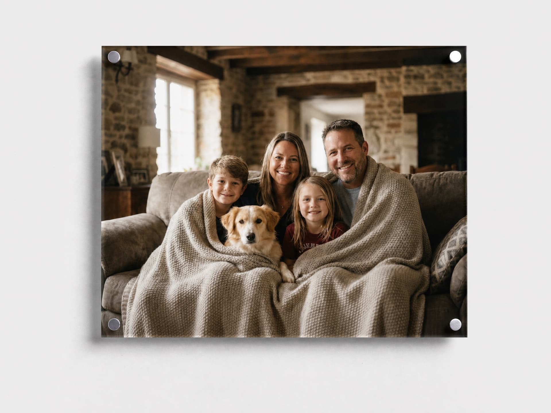 An acrylic wall print featuring a family and their dog together on a sofa